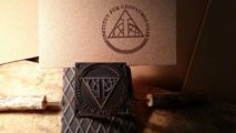 Brandstempel-Werkzeug und gestempelter Kopschinakork des Instituts für Geopathologie